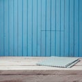 Empty wooden white table with tablecloth over blue wooden wall. Royalty Free Stock Photo