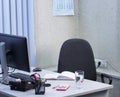 Empty workplace in the office. Chair, desk with office supplies and computer close-up