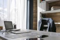 Empty workplace with office desk and chair, jacket on the chair, Royalty Free Stock Photo