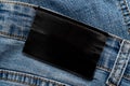 Empty worn leather patch on blue jeans. Empty space for writing. Blank leather jeans label Royalty Free Stock Photo