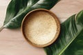 Empty Woven Bamboo Tray with Tropical Leaves on Wooden Surface Royalty Free Stock Photo