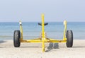 Empty yellow boat trailer on the beach Royalty Free Stock Photo