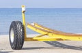 Empty yellow boat trailer on the beach Royalty Free Stock Photo