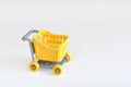 Empty yellow mini shopping cart or store trolley Royalty Free Stock Photo