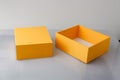 Empty yellow orange cardboard box or carton with cover on grey background, template, mockup Royalty Free Stock Photo