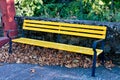 Empty yellow park bench. Royalty Free Stock Photo