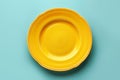 Empty yellow plate on blue background, intermittent fasting concept. Royalty Free Stock Photo