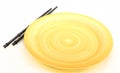 Empty yellow plate with chopsticks Royalty Free Stock Photo