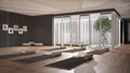Empty yoga studio interior design, open space with mats, pillows and accessories, parquet, patio house, inner garden with tree and Royalty Free Stock Photo