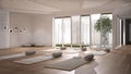 Empty yoga studio interior design, open space with mats, pillows and accessories, parquet, patio house, inner garden with tree and Royalty Free Stock Photo