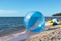 Empty zorb on the inshore waves, water activities, Zorbing extreme attraction for beach vacationers