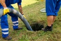 Emptying household septic tank.