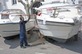 Empuriabrava Black man is washing boat for sale Royalty Free Stock Photo