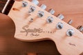 EMPURIABRAVA, SPAIN - FEBRUARY 17, 2021 Guitar headstock of Fender Squier Strat with logo closeup Royalty Free Stock Photo