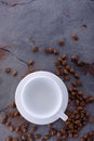 Empy cup and coffee beans on stone kitchen table