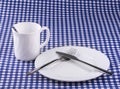 Empy Mug with spoon, plate with a knife and fork Royalty Free Stock Photo