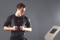 EMS, portrait of young man near electro muscle stimulation machine. Royalty Free Stock Photo