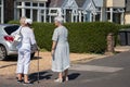 Three elderly women talking in the street