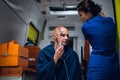 An EMT talking to her patient, who is sitting in an ambulance Royalty Free Stock Photo