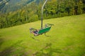 Emtpy chairlift in ski resort. Mountains and hills with in Summer with green trees