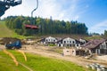 Emtpy chairlift in ski resort. Mountains and hills with in Summer with green trees Royalty Free Stock Photo