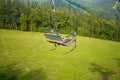 Emtpy chairlift in ski resort. Mountains and hills with in Summer with green trees Royalty Free Stock Photo