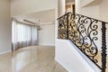 Emtpy house interior. Marble staircase with black wrought iron r