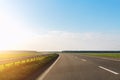 Emtpy view suburaban highway car road with motion blurred fast speed driving against blue sky on background at warm Royalty Free Stock Photo