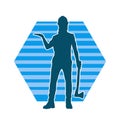 Silhouette of a worker in action pose using his axe tool. Royalty Free Stock Photo