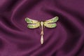 Enamel brooch with golden dragonfly with diamonds on silk fabric