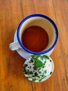 Old-fashioned looking enamel cup containing tea