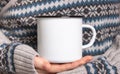 Enamel Mug with black edge line Mock-up. Girl holds white old-tin campfire cup in her hands Royalty Free Stock Photo