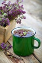 Enameled mug of thyme healing herbs.