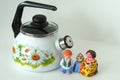 Enamelled utensils. Beautiful white enamelled kettle with whistle and pattern.
