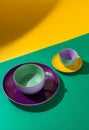 Mockup enamelware on yellow, purple and green background. Ad posters. Minimalistic color enamel objects.