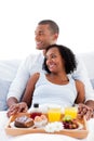 Enamored couple having breakfast on their bed Royalty Free Stock Photo