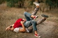 Enamored couple lies, smiles and embraces on forest path. Royalty Free Stock Photo