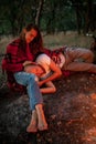 Enamored couple on picnic in forest.