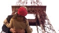 Enamored man passionately kissing beloved woman on romantic date in Paris