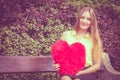 Enamored woman with big red heart