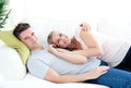 Enamored young couple lyingo together on the sofa