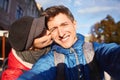 Enamoured couple hugging, kissing and making selfie during the city walk Royalty Free Stock Photo