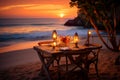 An enchanting beach dining experience as the setting sun bathes love in warm hues