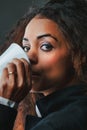 Black woman, sipping coffee, exudes power, knowledge Royalty Free Stock Photo