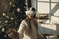 An enchanting portrait of a girl with a VR headset, set against the festive scene of a Christmas tree.