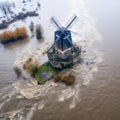 Enchanting Reflections: Aerial View of Dutch Windmill in Flooded Fields