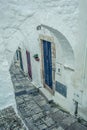 Discover the Hidden Charm of Ostuni\'s Historical White Alleyway Through a Medieval Archway with Stunning Blue Door View