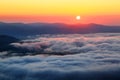 Enchanting sunrise at the high mountains, and at the bottom there is textured thick fog. Royalty Free Stock Photo