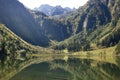 Enchanting valley with reflecting lake water and waterfall in the background Steierischer Bodensee, Austria Royalty Free Stock Photo