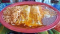 Tamale and enchilada combo